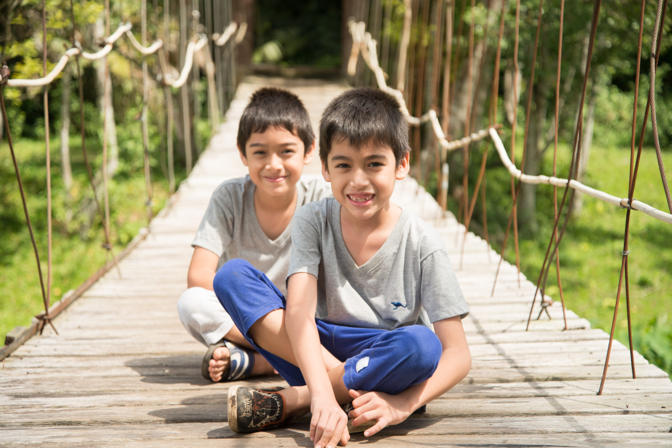 little boy sitting together over the bridge outdoor activities